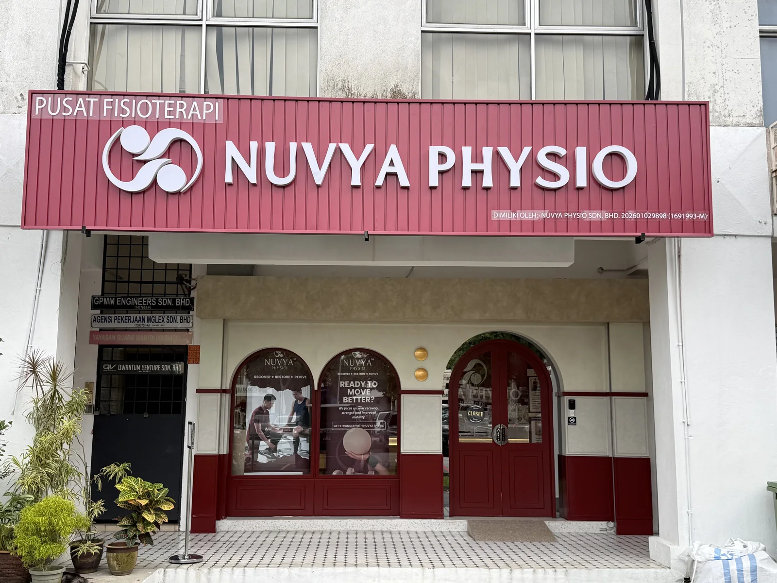 Nuvya Physio shopfront with the burgundy signage and arched doors